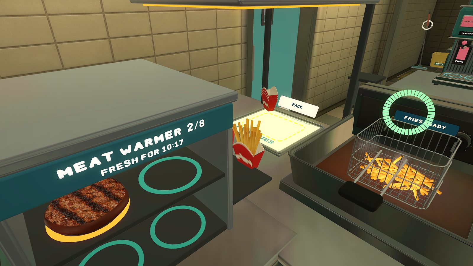 Fries ready in the fryer basket next to the meat warmer